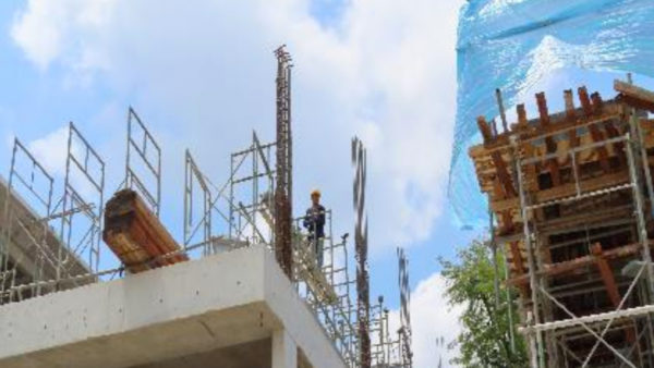 Government inspectors photographed this worker on the third floor of a structure at a Wah Khiaw Developments site. The man worked without barricades, a fall-arrest system, or a safety harness (Singapore Ministry of Manpower)